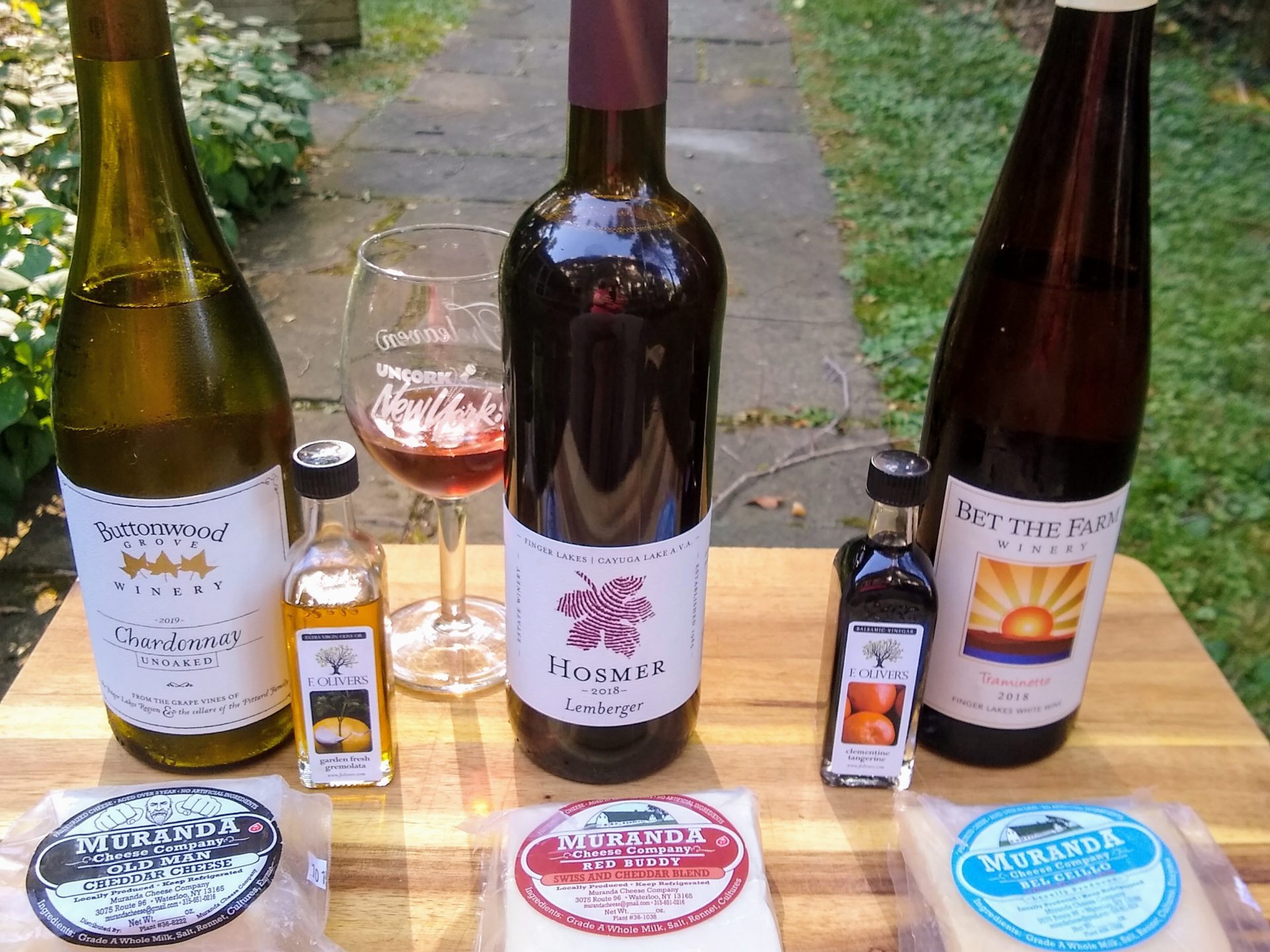 bottles of wine on a table with cheese