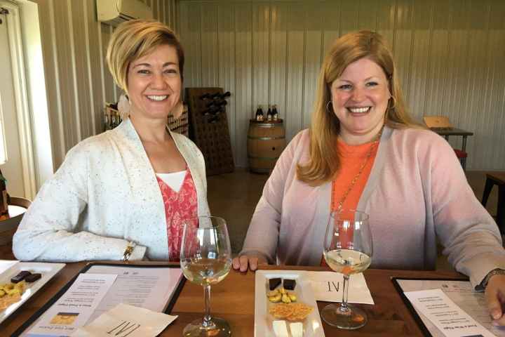 a couple of people sitting at a table with wine glasses