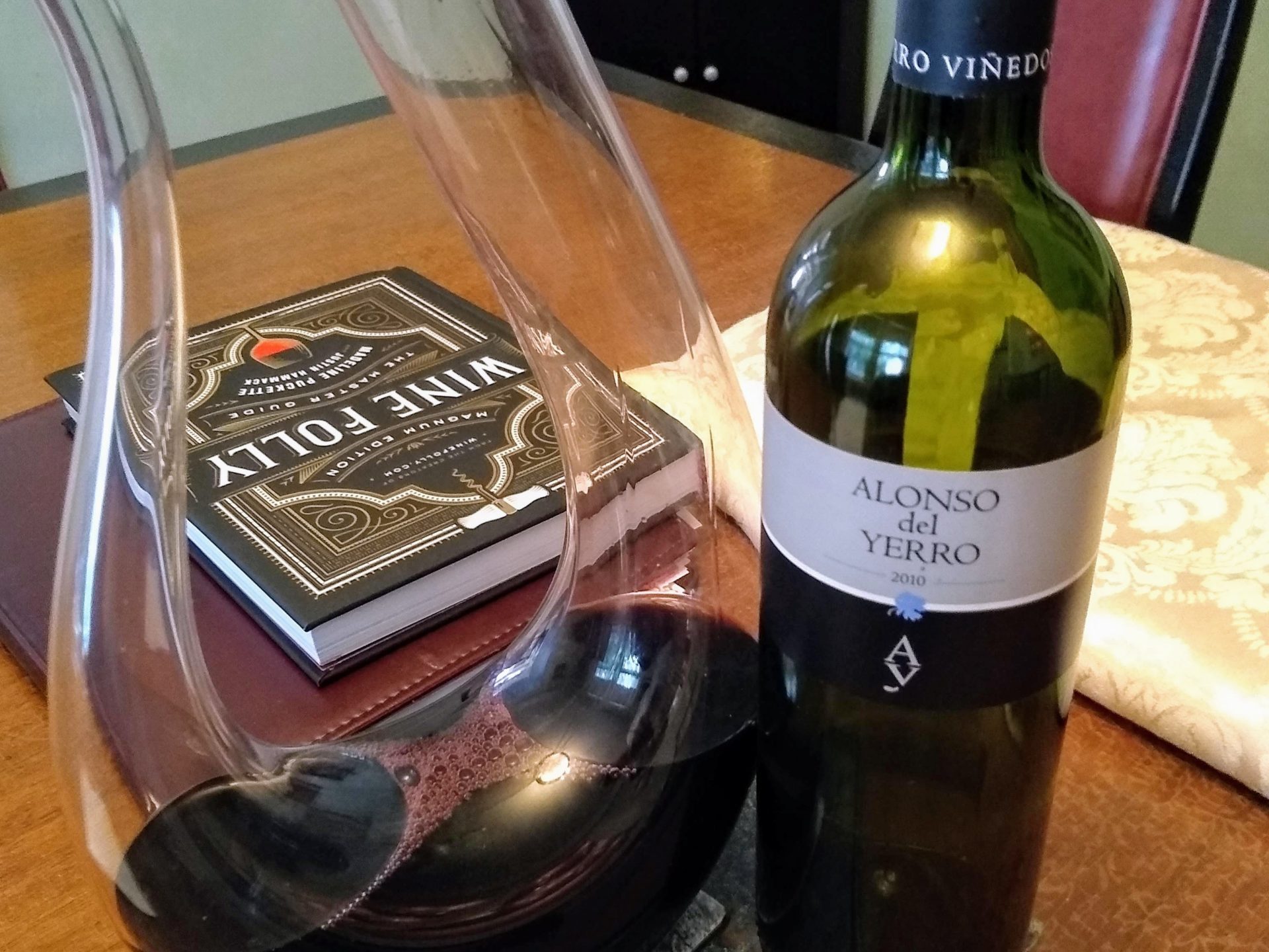 a bottle of wine sitting on top of a wooden table