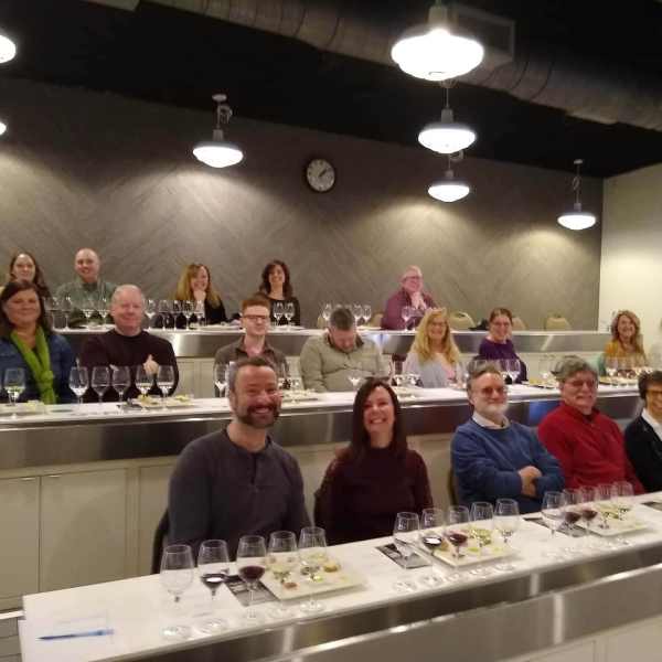 wine presentation a group of people standing in front of a mirror posing for the camera