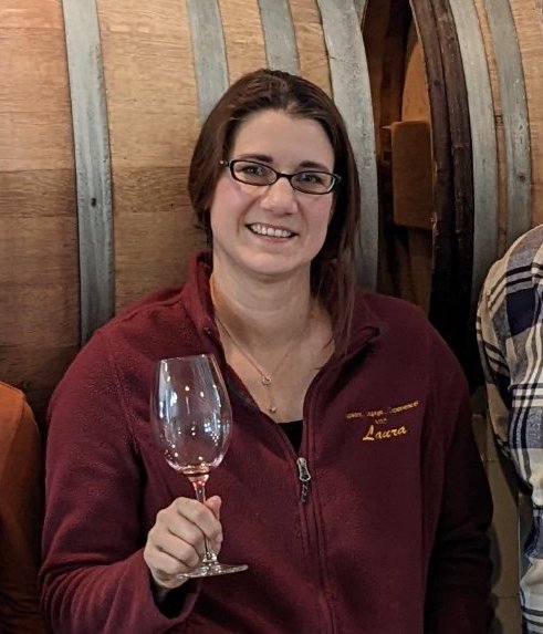 a person holding a wine glass posing for the camera