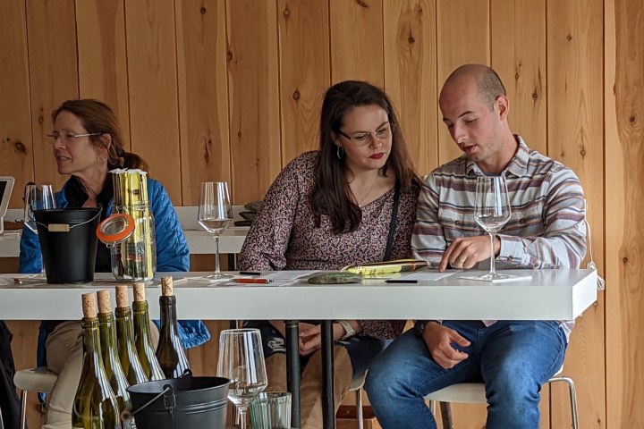 a group of people sitting around a wooden table