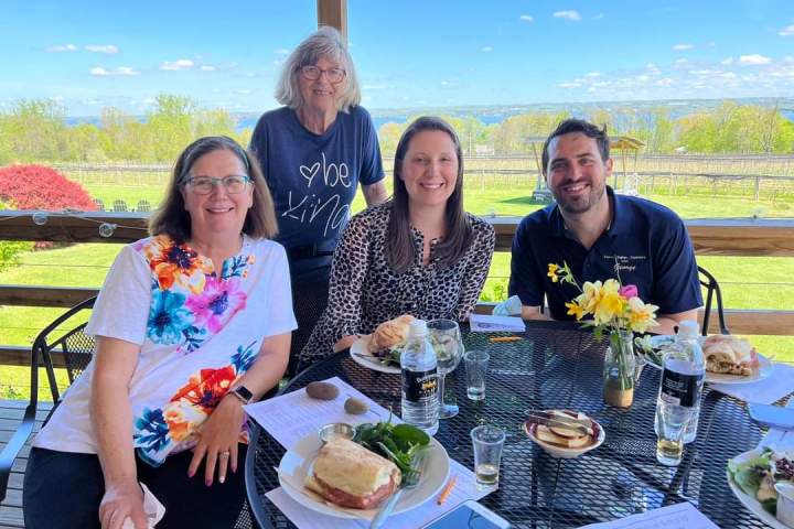 a group of people sitting at a table with food