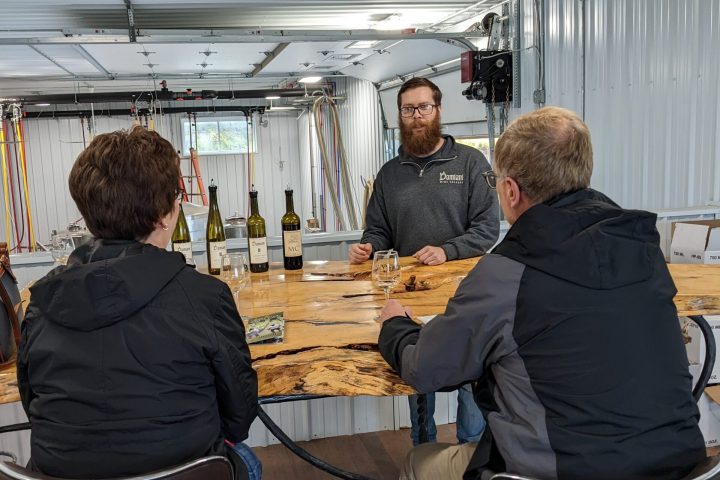 a group of people standing around a table