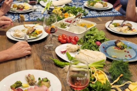 a group of people sitting at a table eating food
