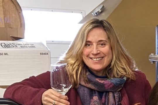 a woman holding a wine glass posing for the camera