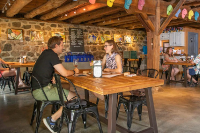a group of people sitting at a table in a restaurant