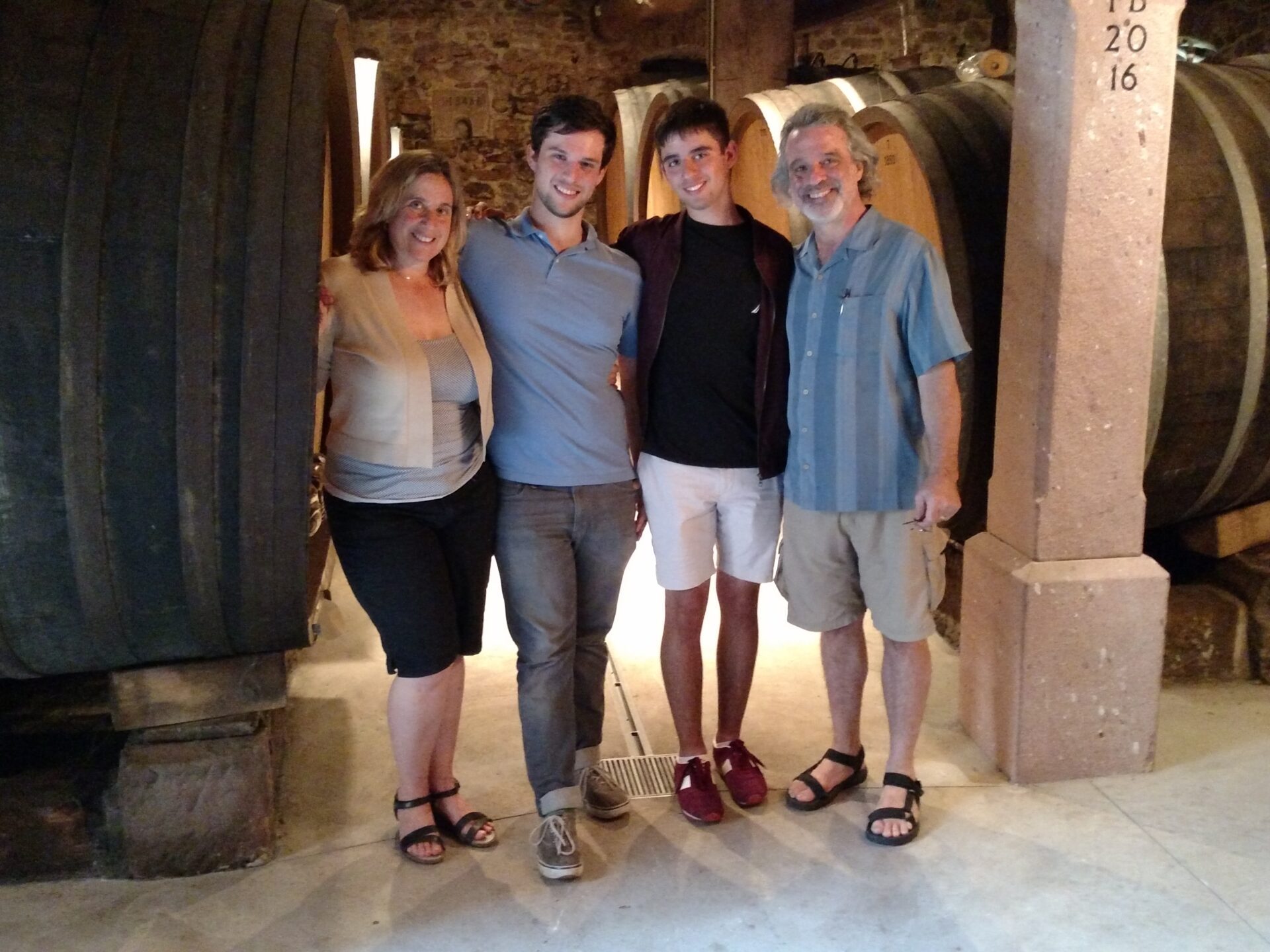 family standing in front of a barrel