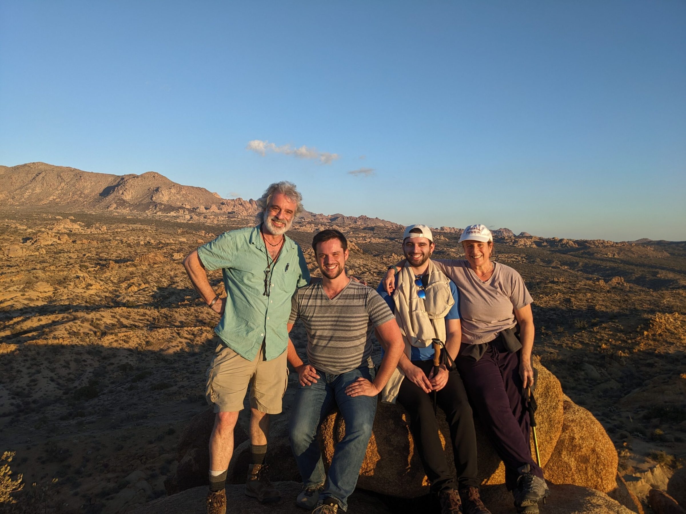 a group of people standing on top of a mountain