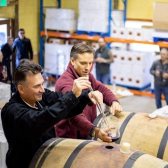a group of people in front of a barrel