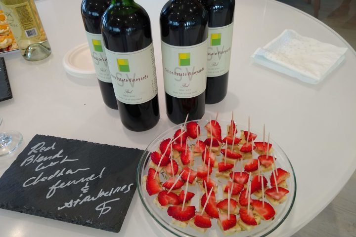 a bottle of wine on a table with a plate of food