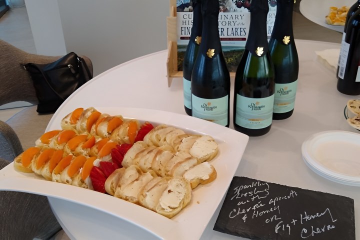 a plate of food and a bottle of wine on a table