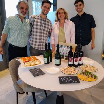a group of people standing around a table