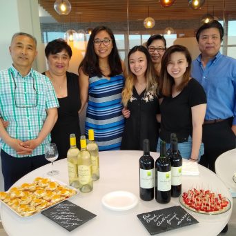 a group of people standing around a table posing for the camera