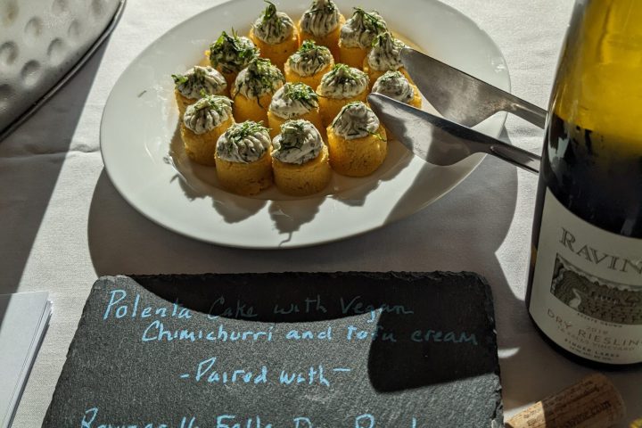 a plate of food and a bottle of wine on a table