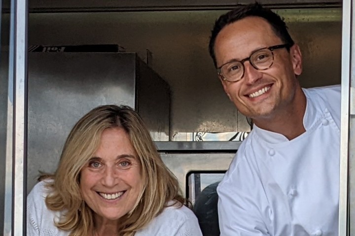 a smiling man and woman posing for the camera