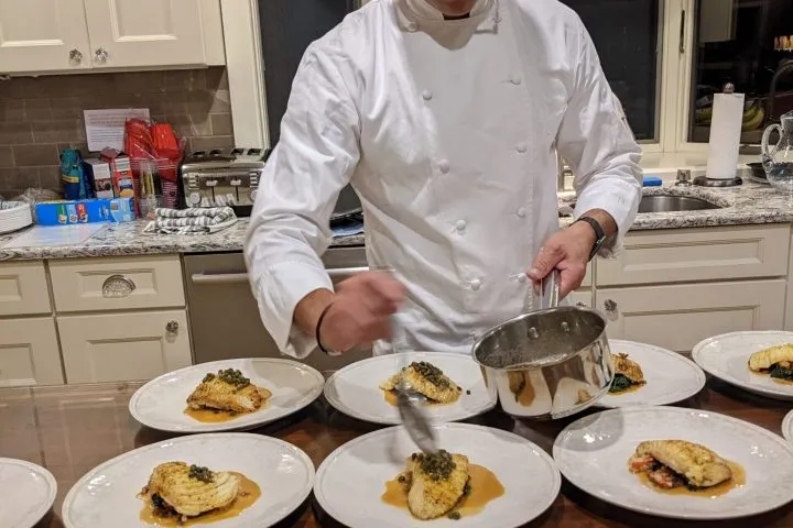 a person sitting at a table with a plate of food