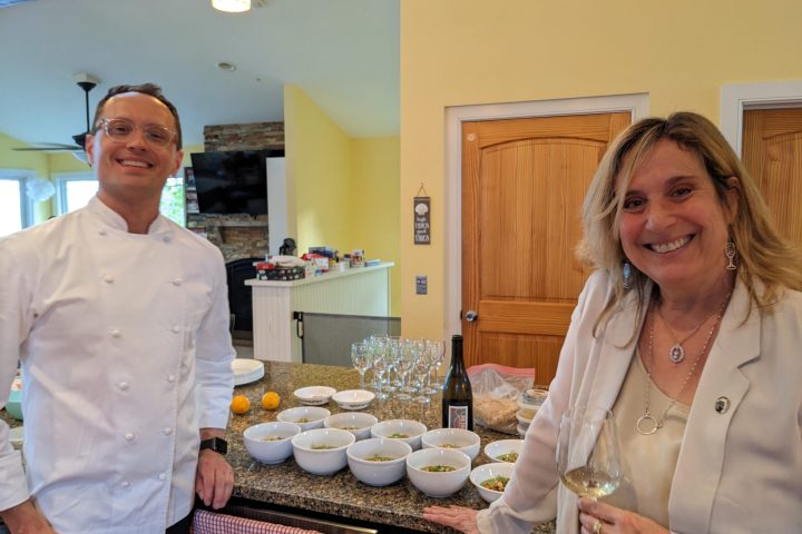 a man and a woman standing in a kitchen preparing food