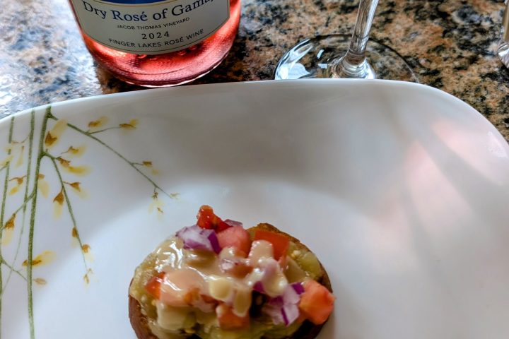 a plate of food and a glass of wine