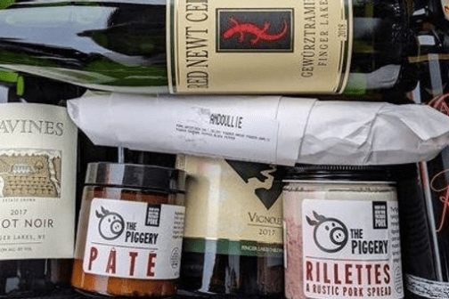 a bottle of wine next to a book