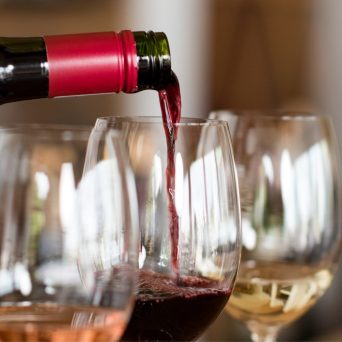 a close up of a bottle and a glass of wine