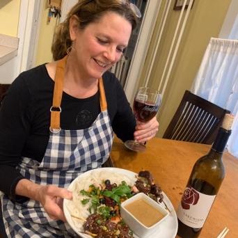a person sitting at a table with a plate of food
