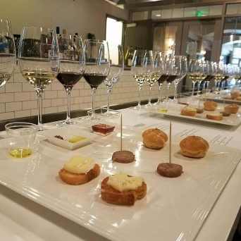 a table topped with plates of food and glasses of wine