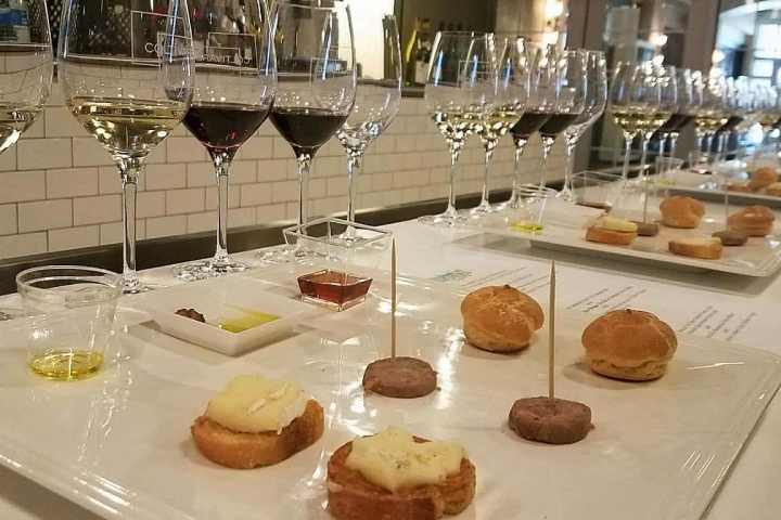 a table topped with plates of food and glasses of wine