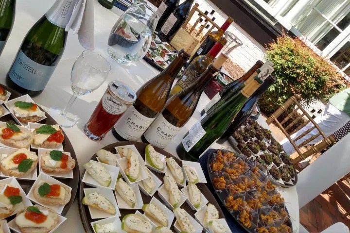 a bottle of wine and a plate of food on a table