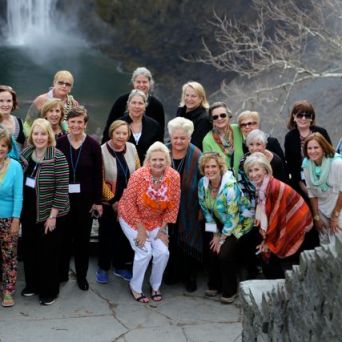 a group of people standing in front of a crowd posing for the camera